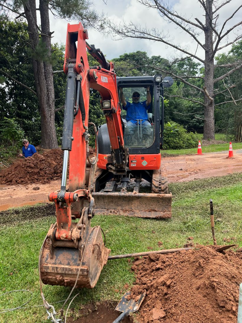 Working hard on repairing leak under N Bayou Des Glaises Rd.