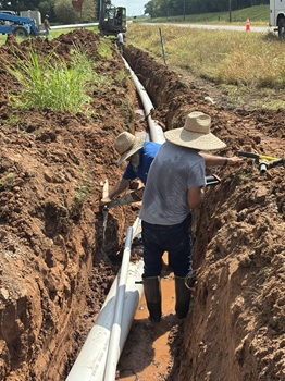 Operators repairing a break on Hwy 451-Big Bend area